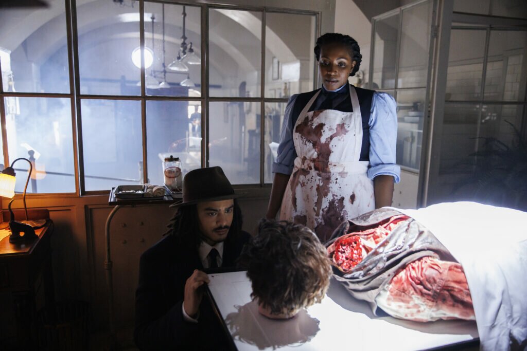 Gabriel Darku as Kenneth Rijkers and Lisa Berry as Dr. Melanda Israel in Slasher: Ripper (Season 5, Episode 2). Photo Credit: Cole Burston/Shudder